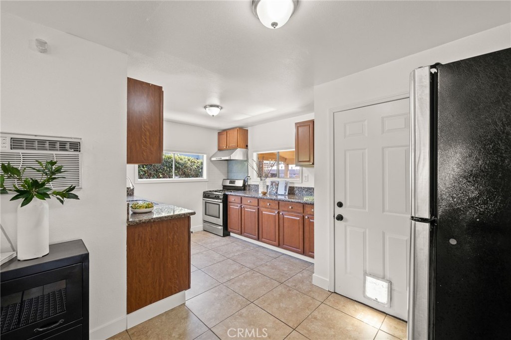 752 North Toledo Walk Long Beach, CA 90813 - Photo 12 of 32 a kitchen with stainless steel appliances granite countertop a refrigerator and a sink