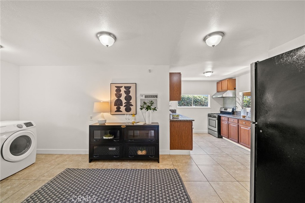 752 North Toledo Walk Long Beach, CA 90813 - Photo 13 of 32 a kitchen with stainless steel appliances a stove a refrigerator and cabinets