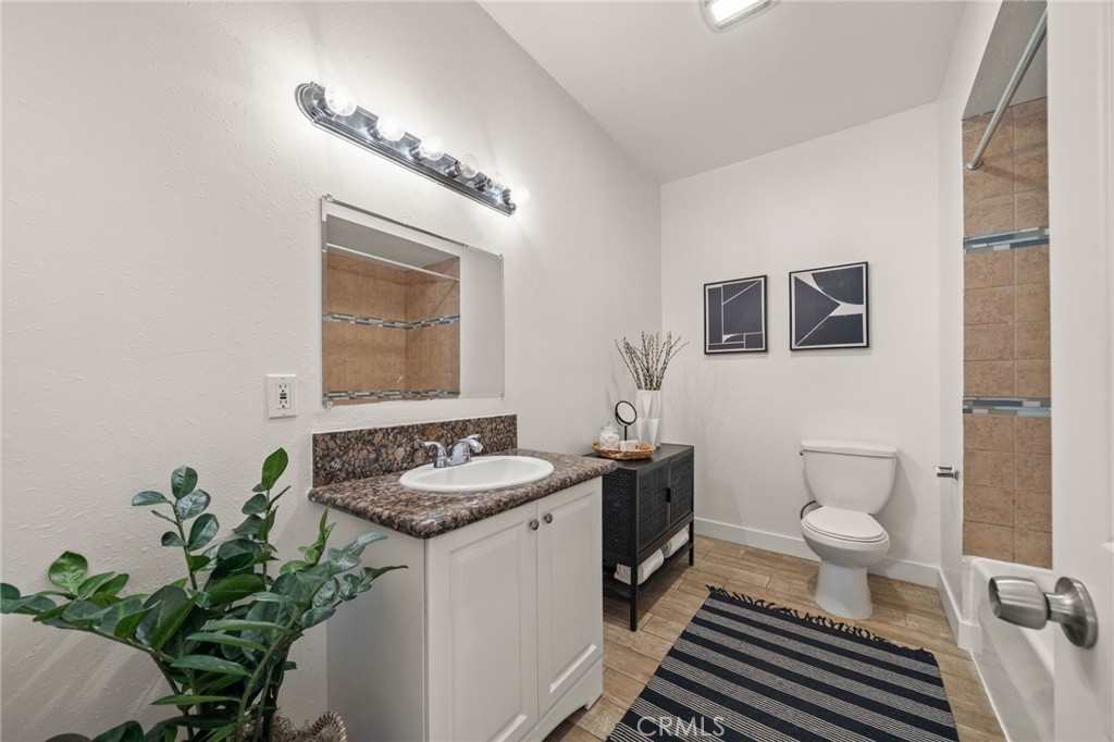 752 North Toledo Walk Long Beach, CA 90813 - Photo 17 of 32 a bathroom with a granite countertop sink and a mirror
