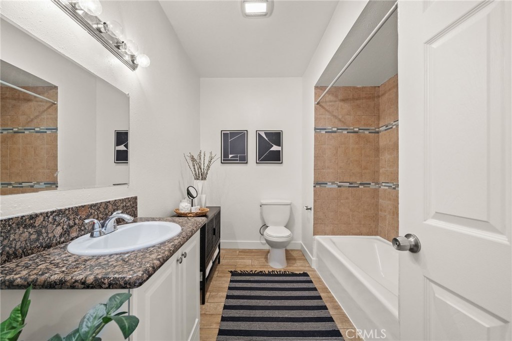 752 North Toledo Walk Long Beach, CA 90813 - Photo 18 of 32 a bathroom with a granite countertop sink and a mirror