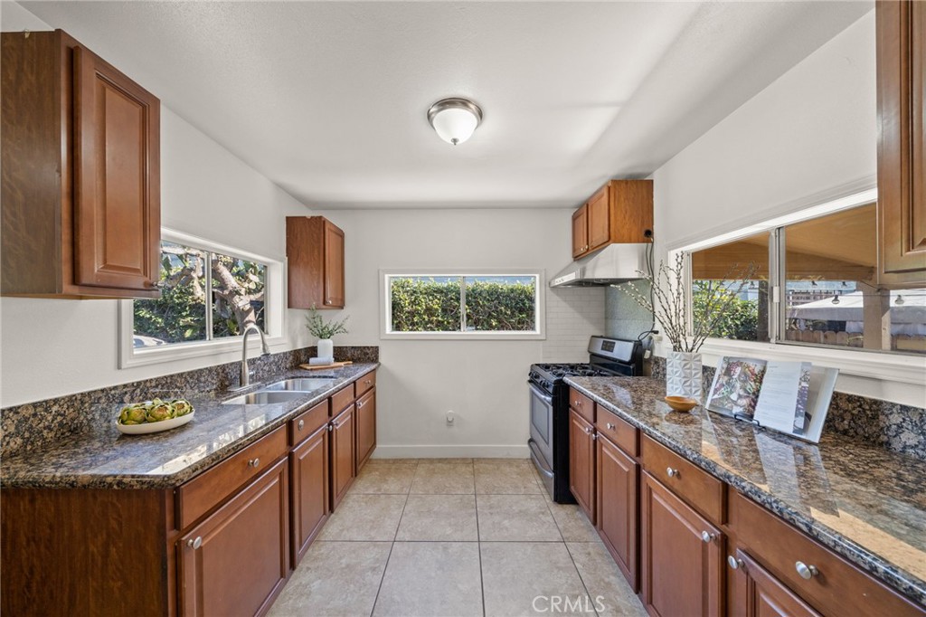 752 North Toledo Walk Long Beach, CA 90813 - Photo 8 of 32 a kitchen with a sink stove and cabinets