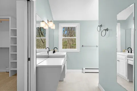 a bathroom with a sink vanity and a mirror