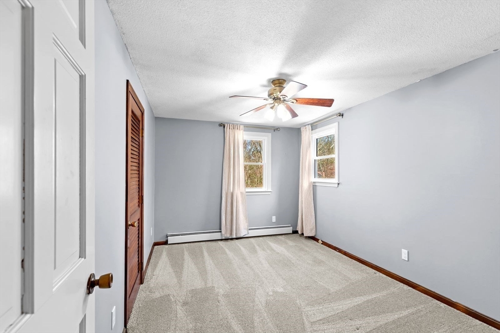36 Cooke Road Plymouth, MA 02360 - Photo 26 of 37 an empty room with windows and chandelier fan