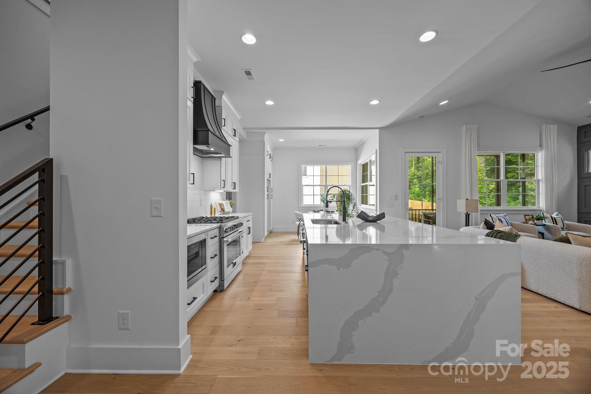 3945 Plainview Road Charlotte, NC 28208 - Photo 20 of 47 a large living room with stainless steel appliances granite countertop a couch and a large window