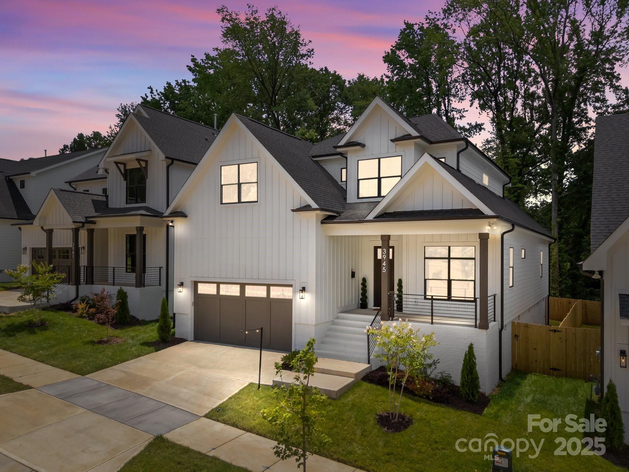 3945 Plainview Road Charlotte, NC 28208 - Photo 2 of 47 a front view of a house with a yard and garage