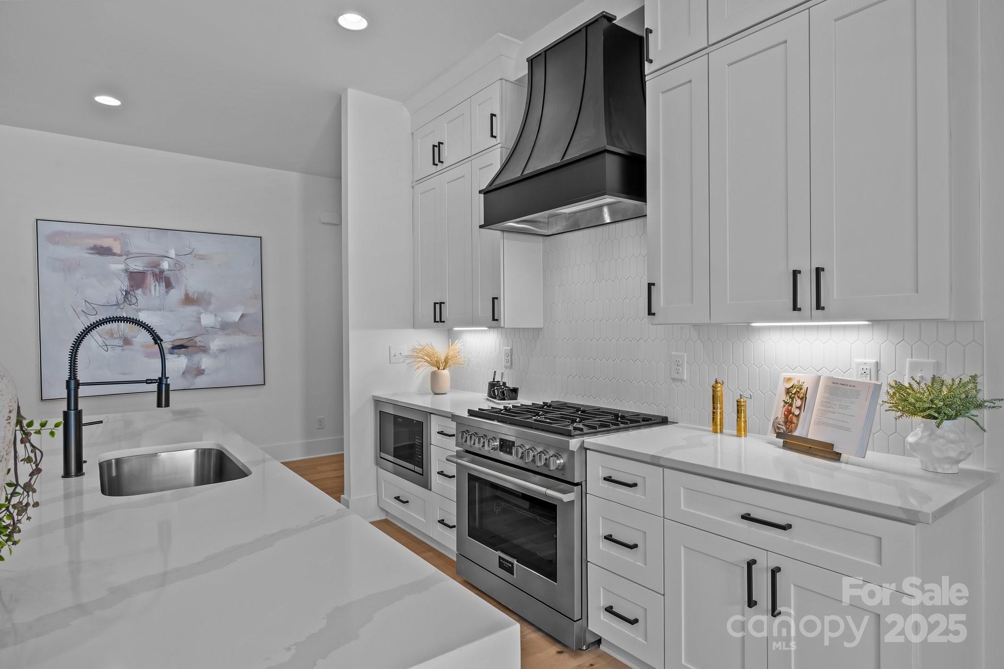 3945 Plainview Road Charlotte, NC 28208 - Photo 24 of 47 a kitchen with white cabinets and appliances