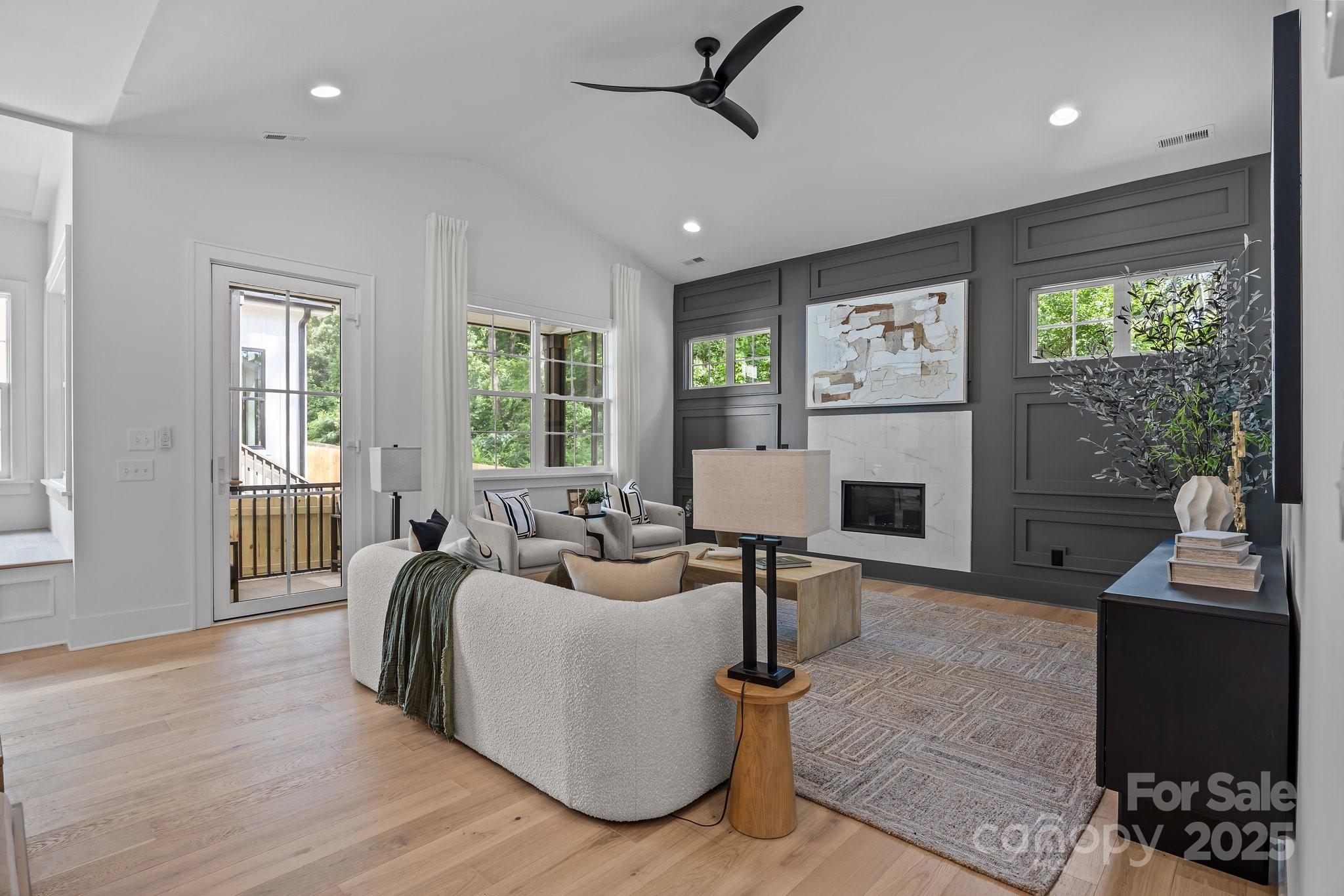 3945 Plainview Road Charlotte, NC 28208 - Photo 29 of 47 a living room with furniture a large window and a wooden floor