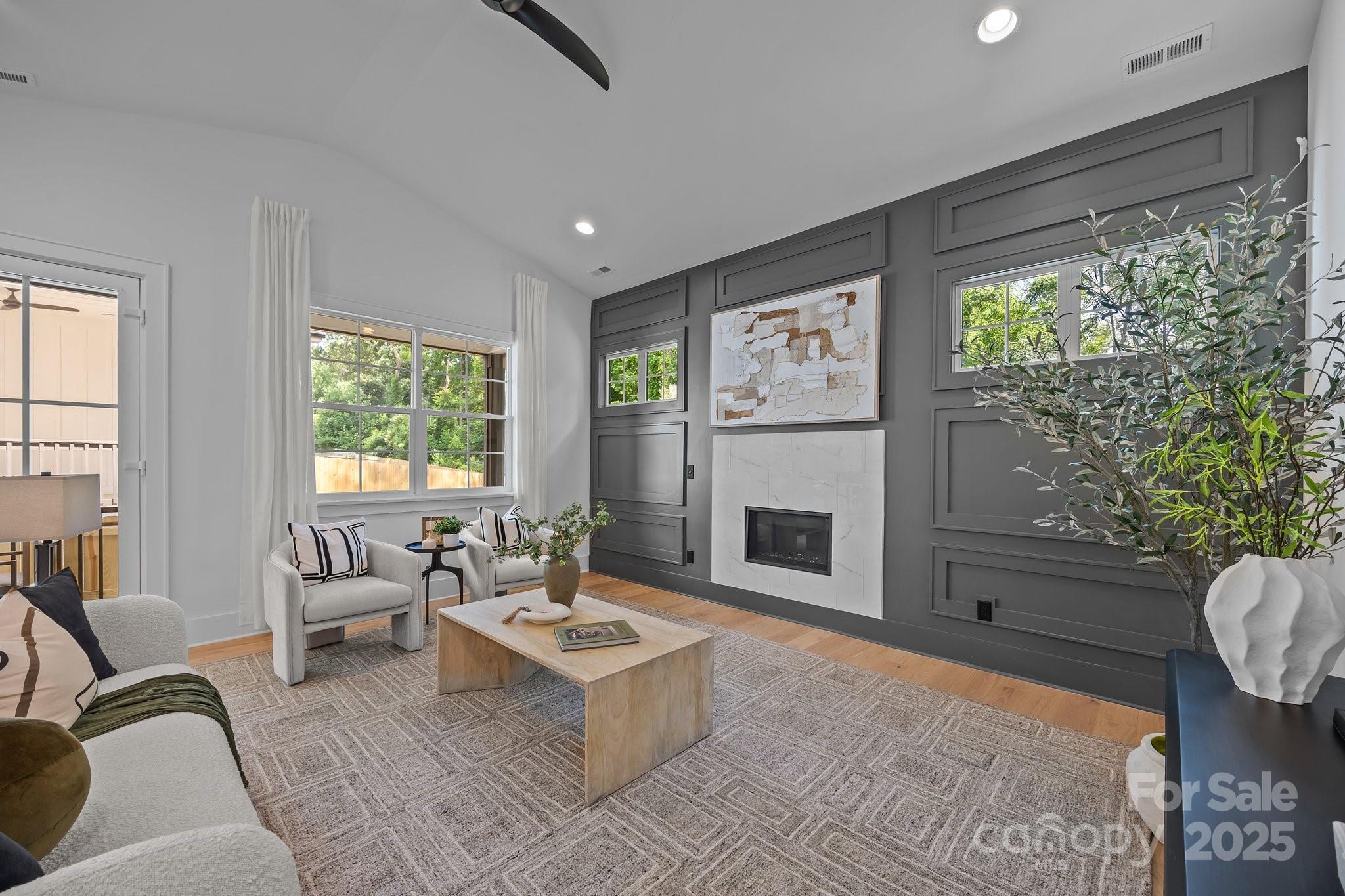 3945 Plainview Road Charlotte, NC 28208 - Photo 31 of 47 a living room with furniture a large window and a fireplace