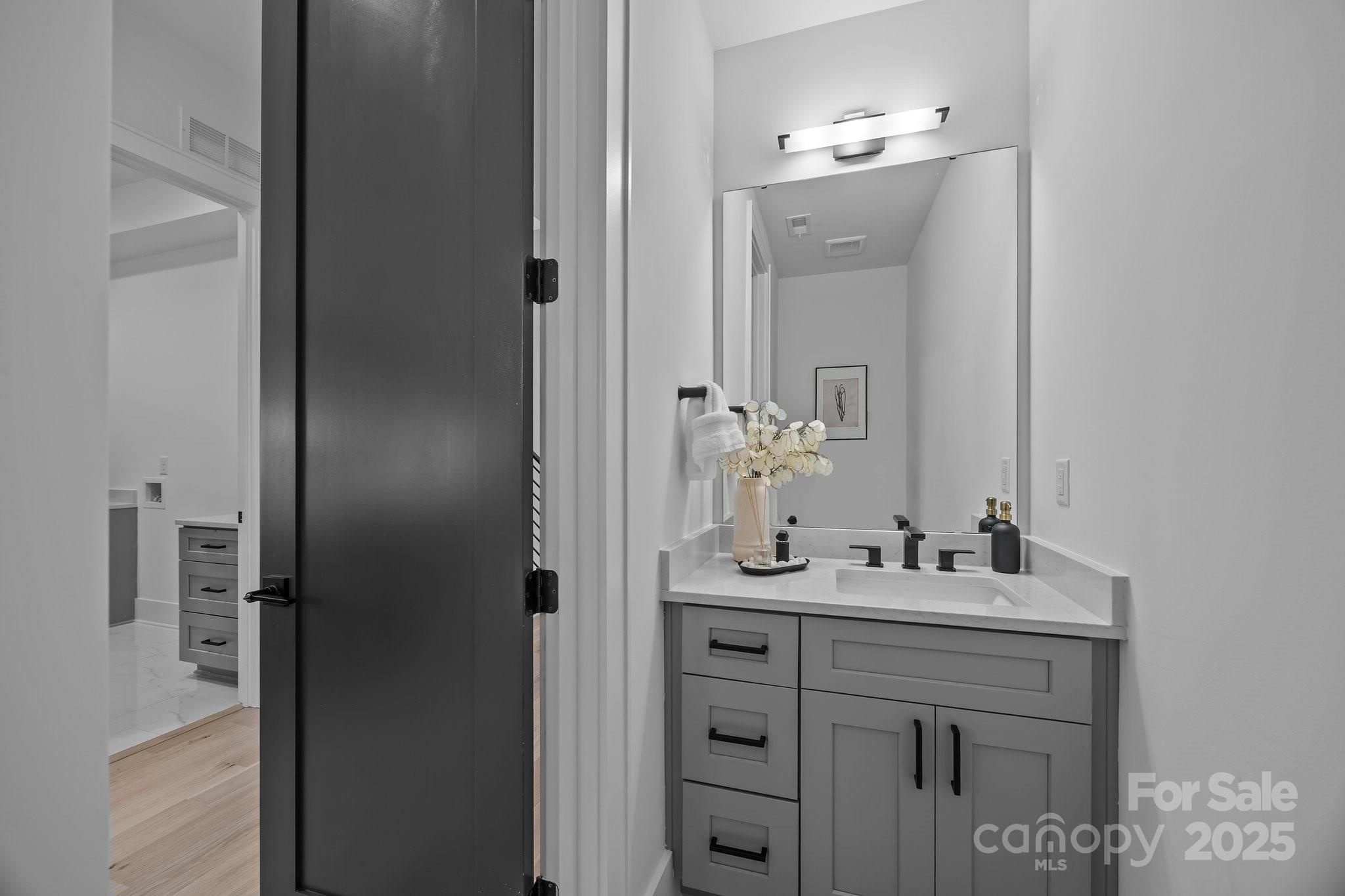 3945 Plainview Road Charlotte, NC 28208 - Photo 33 of 47 a bathroom with a sink vanity and a mirror