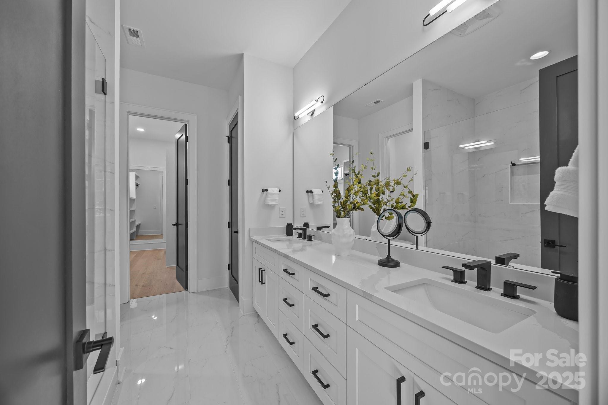 3945 Plainview Road Charlotte, NC 28208 - Photo 35 of 47 a bathroom with a double vanity sink mirror and shower