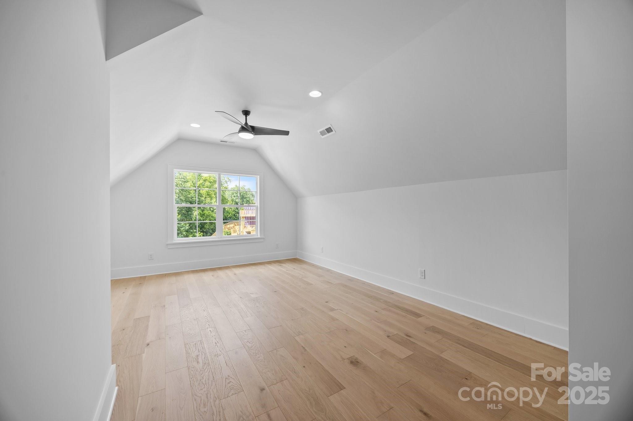 3945 Plainview Road Charlotte, NC 28208 - Photo 43 of 47 an empty room with a window and a ceiling fan