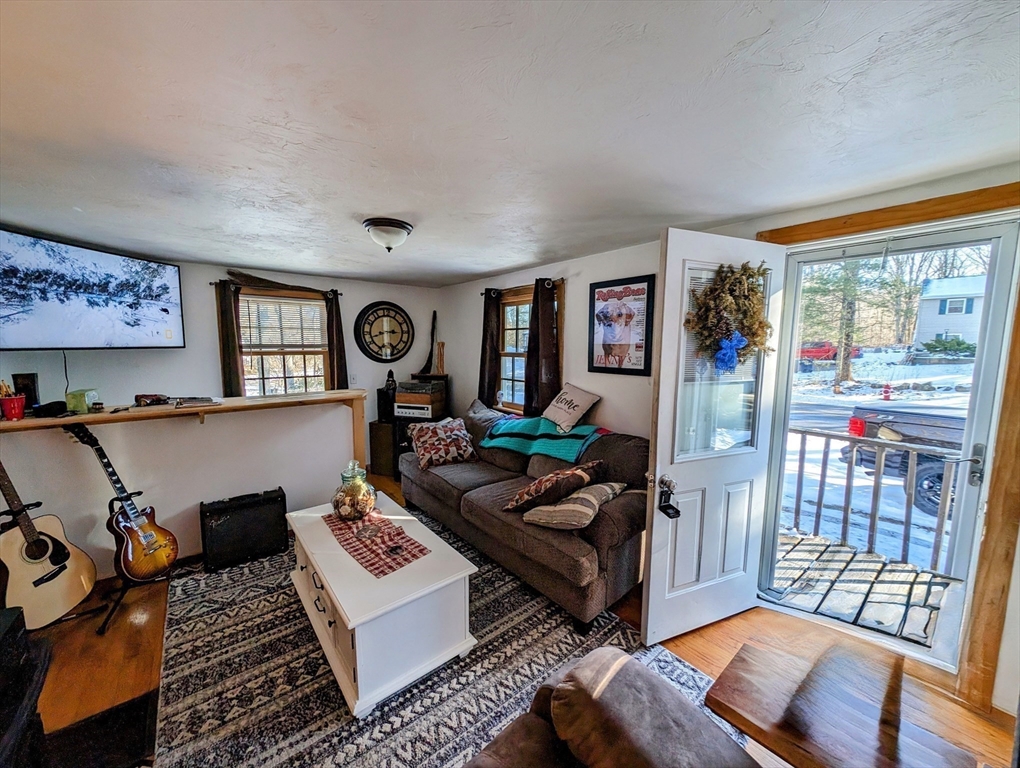 138 Old Worcester Road Charlton, MA 01507 - Photo 14 of 33 a living room with furniture and a floor to ceiling window