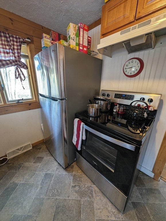 138 Old Worcester Road Charlton, MA 01507 - Photo 19 of 33 a kitchen with stainless steel appliances granite countertop a stove and a refrigerator