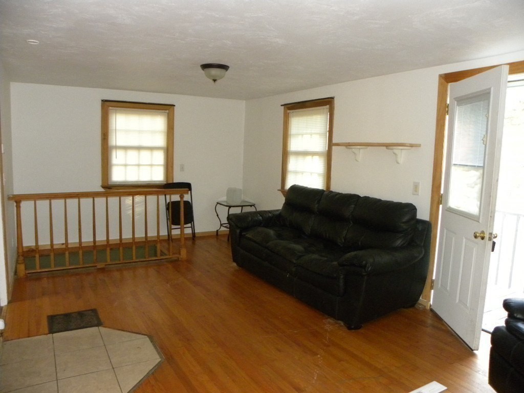 138 Old Worcester Road Charlton, MA 01507 - Photo 2 of 33 a living room with a couch and a window
