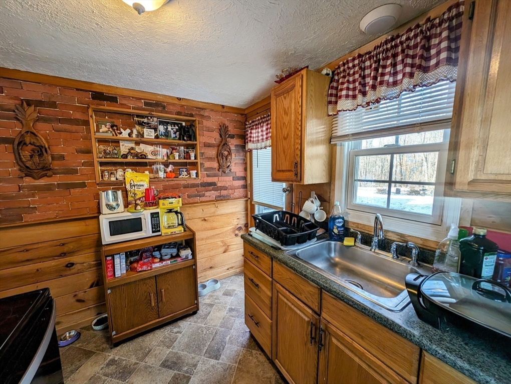 138 Old Worcester Road Charlton, MA 01507 - Photo 5 of 33 a kitchen with stainless steel appliances a sink window and cabinets