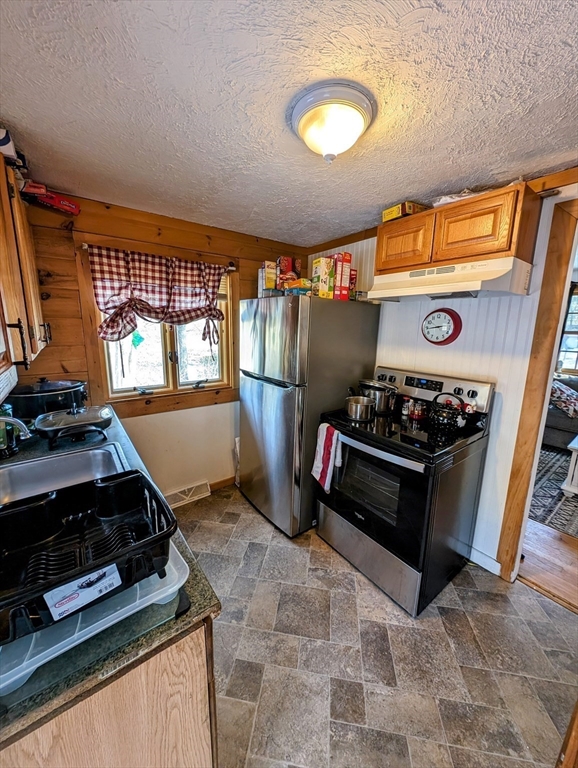 138 Old Worcester Road Charlton, MA 01507 - Photo 6 of 33 a kitchen with stainless steel appliances granite countertop a stove and a sink