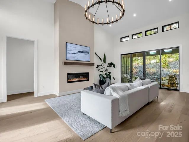 a living room with furniture a dining table and a fireplace