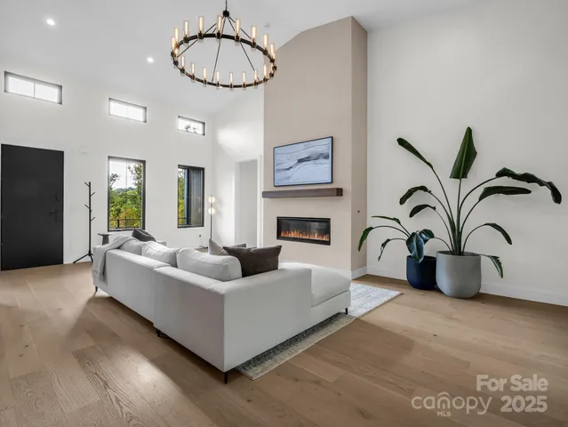 a living room with furniture a dining table and kitchen view