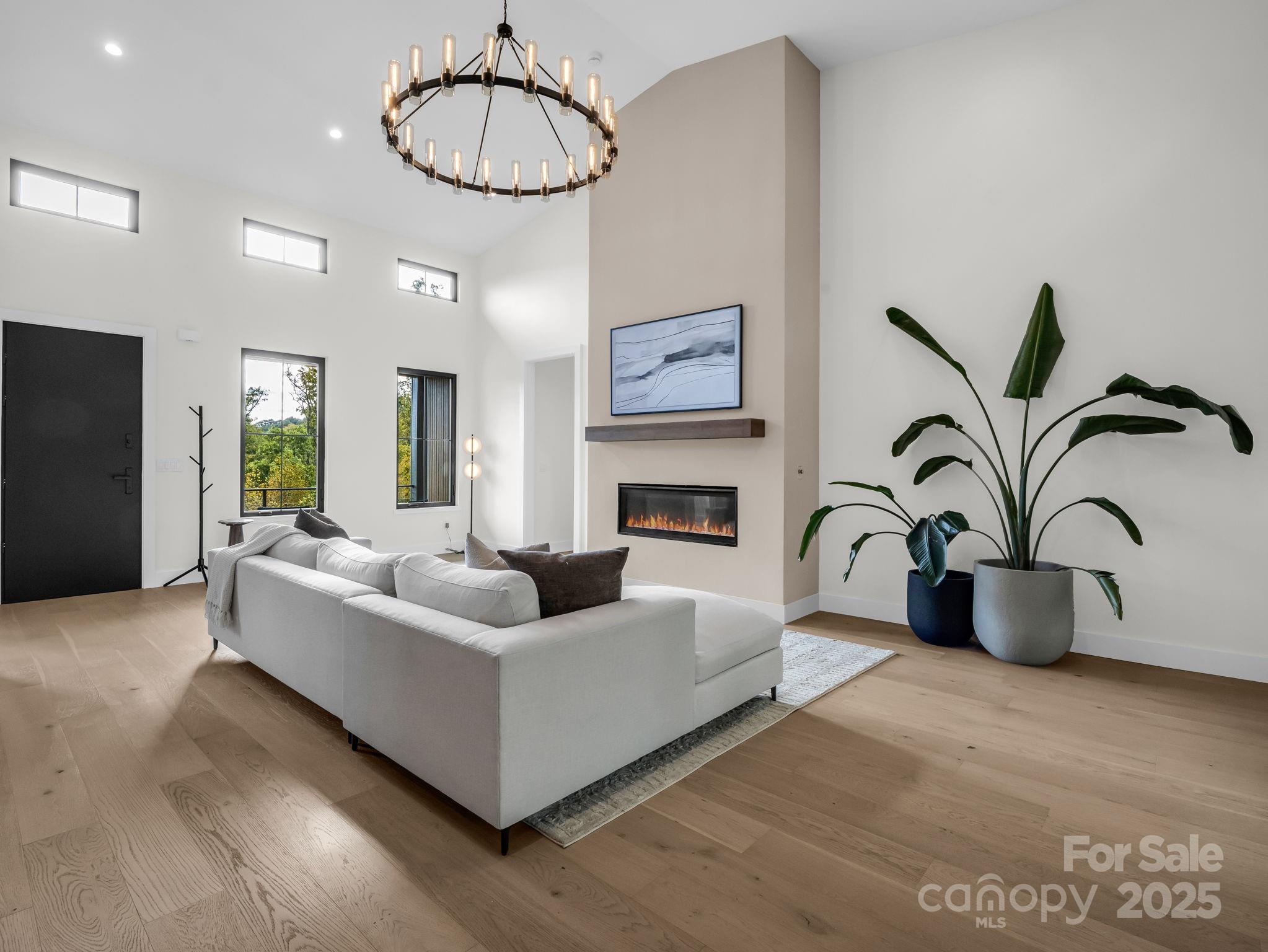 123 Millbrae Loop Hendersonville, NC 28791 - Photo 16 of 48 a living room with furniture a dining table and a fireplace