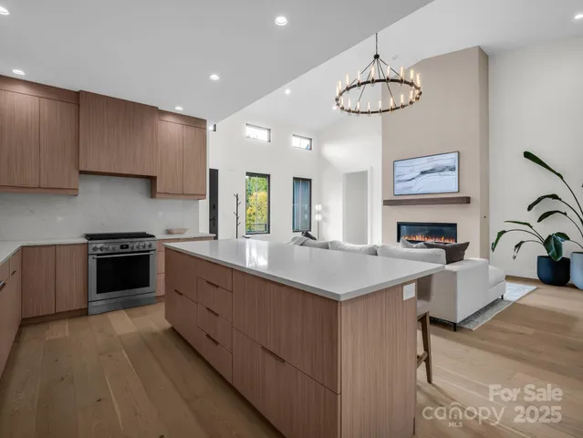 a kitchen with kitchen island a refrigerator stove and microwave