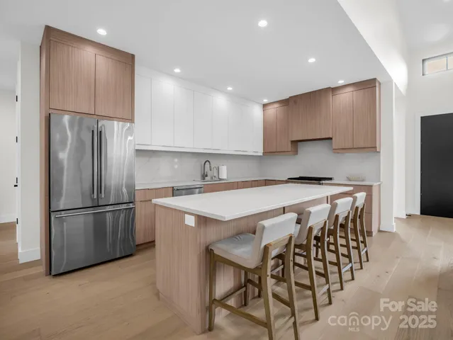 a kitchen with stainless steel appliances granite countertop a sink and a stove