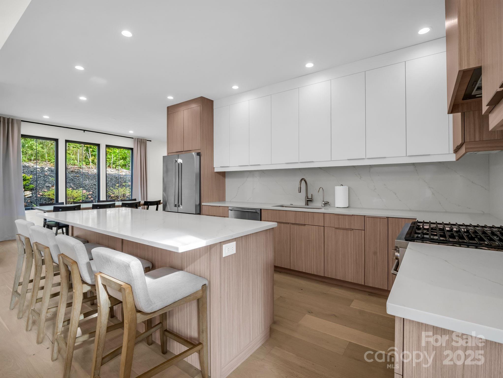 123 Millbrae Loop Hendersonville, NC 28791 - Photo 20 of 48 a kitchen with stainless steel appliances granite countertop a sink and a stove