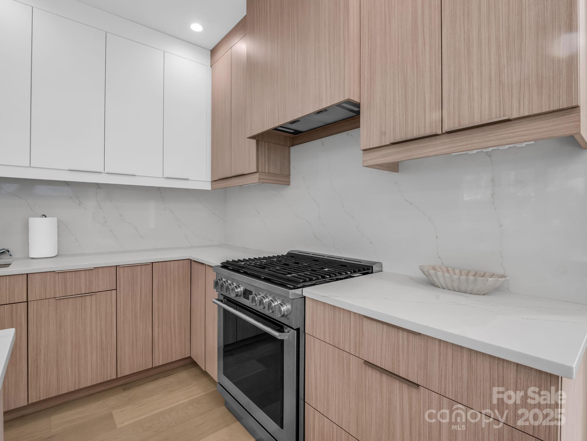 123 Millbrae Loop Hendersonville, NC 28791 - Photo 21 of 48 a kitchen with granite countertop white cabinets and white appliances