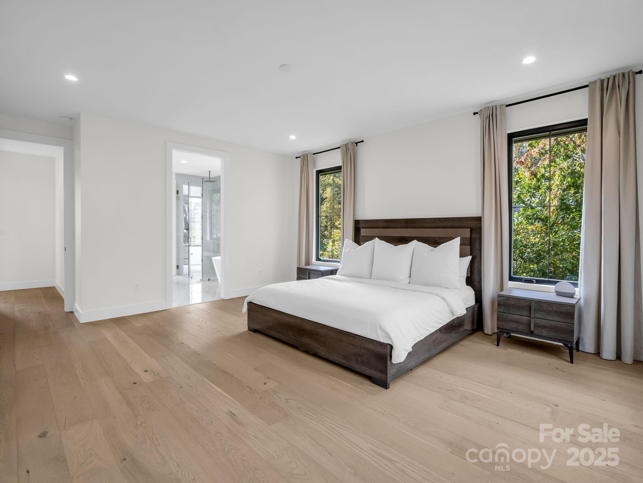 123 Millbrae Loop Hendersonville, NC 28791 - Photo 29 of 48 a spacious bedroom with a bed and a large window