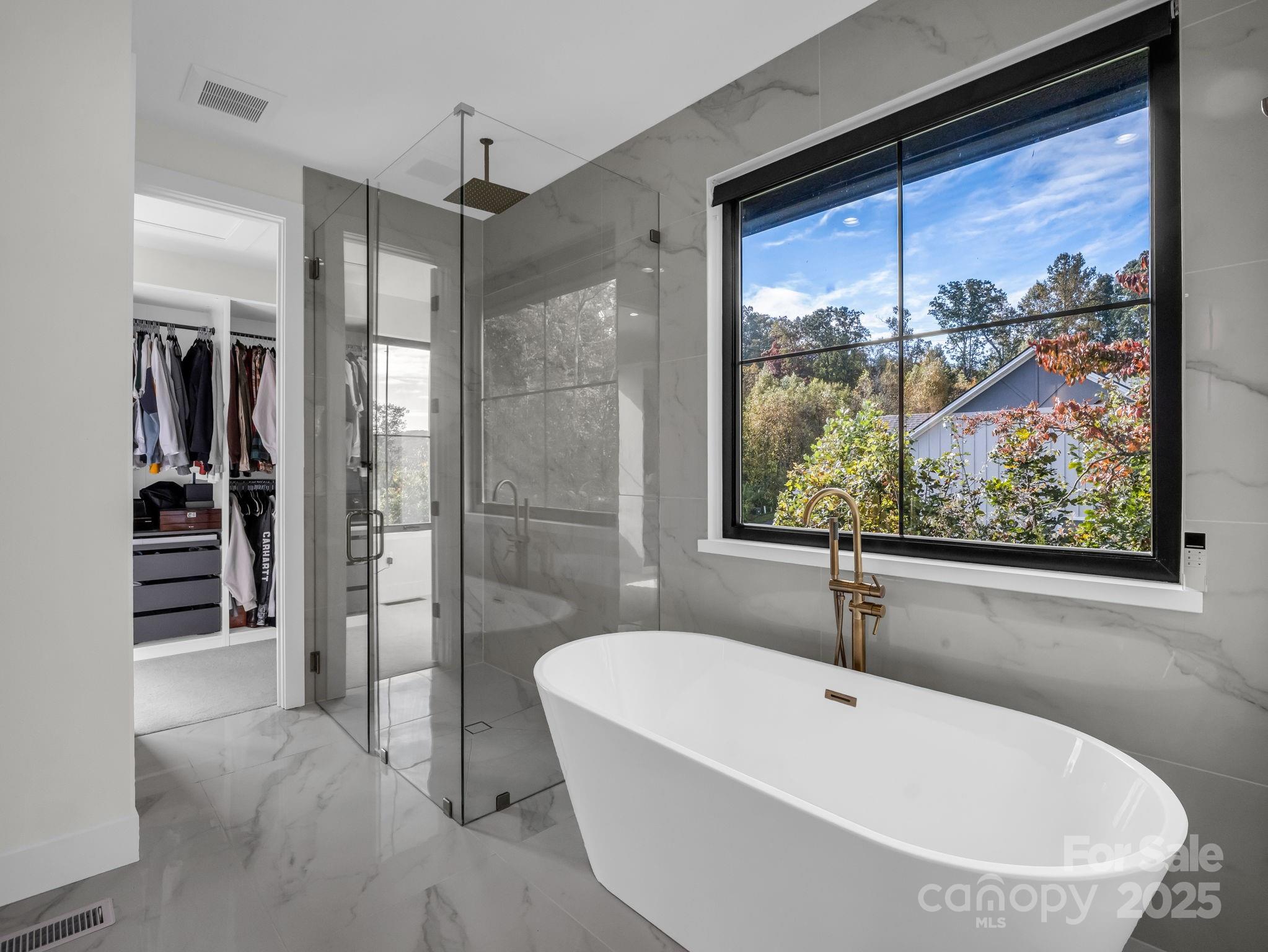123 Millbrae Loop Hendersonville, NC 28791 - Photo 31 of 48 a bathroom with a tub and a window