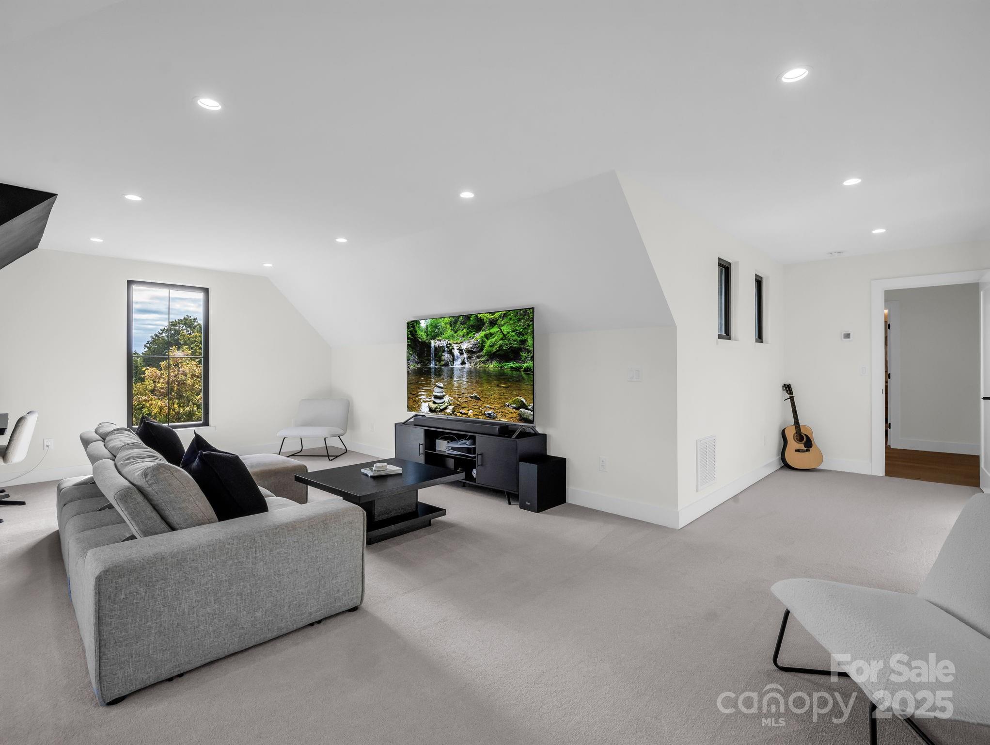 123 Millbrae Loop Hendersonville, NC 28791 - Photo 36 of 48 a living room with furniture and a flat screen tv