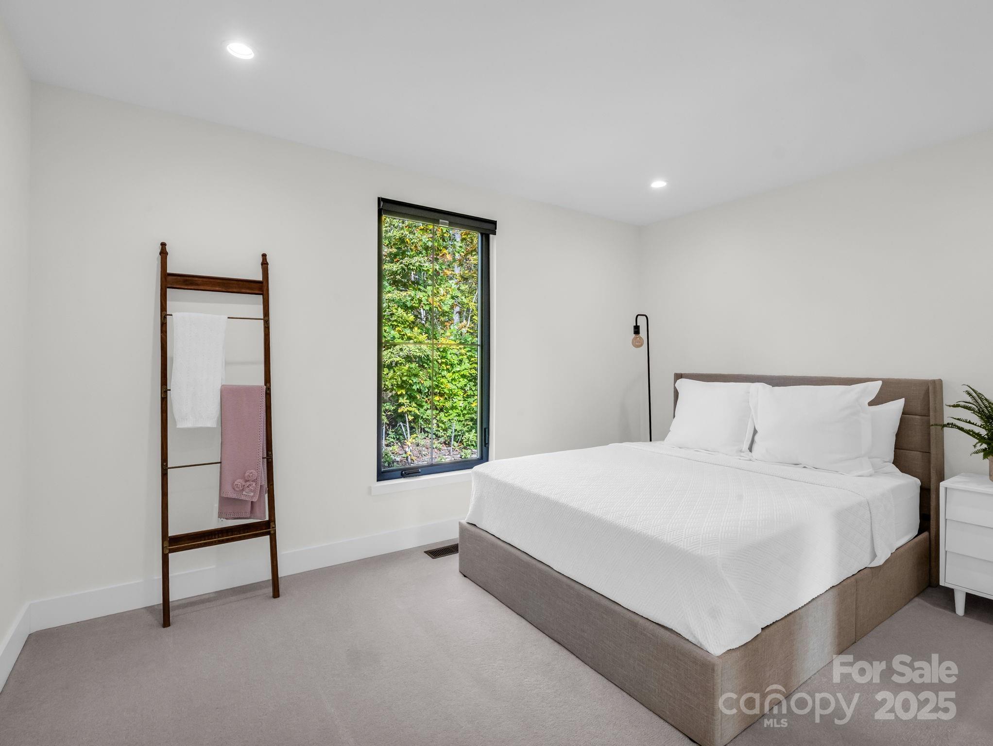 123 Millbrae Loop Hendersonville, NC 28791 - Photo 39 of 48 a bedroom with a bed and a window