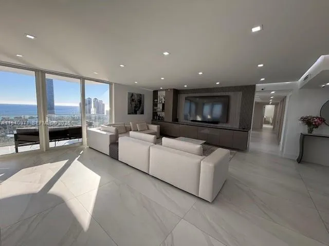 a bedroom with a bed and a flat tv screen on a dresser