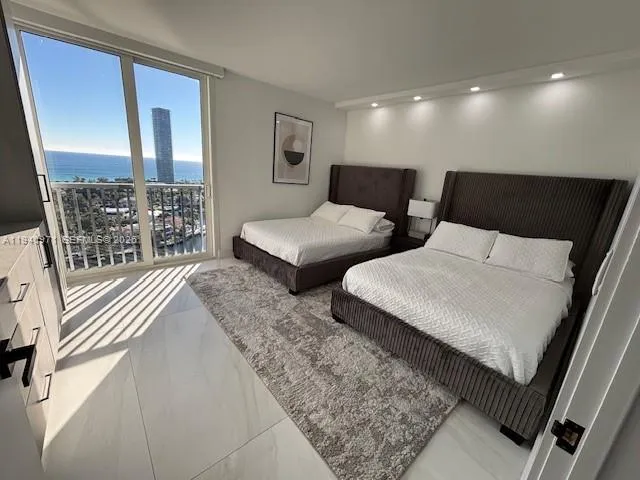 a spacious bedroom with a bed and glass window