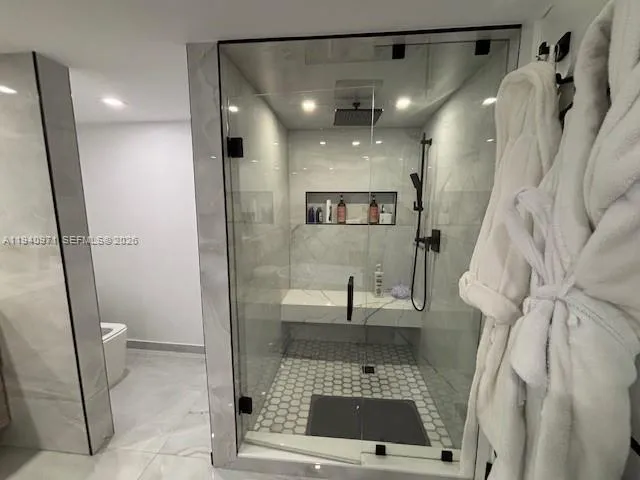 a spacious bedroom with a bed and a flat screen tv