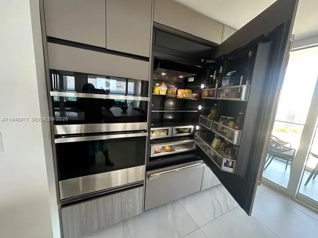 a kitchen with a refrigerator and a stove top oven