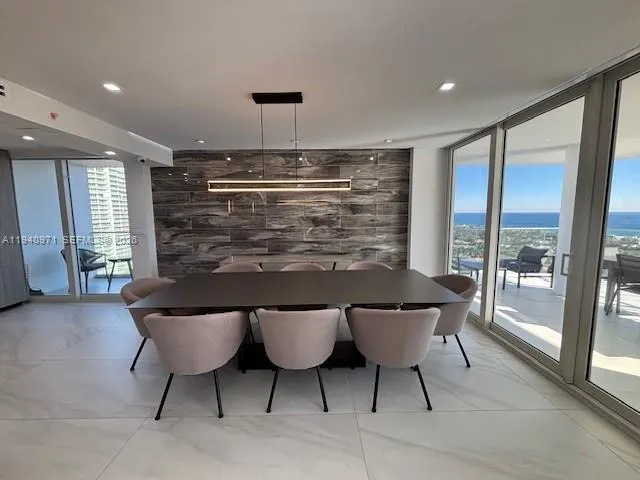 a kitchen with kitchen island granite countertop a stove and a sink