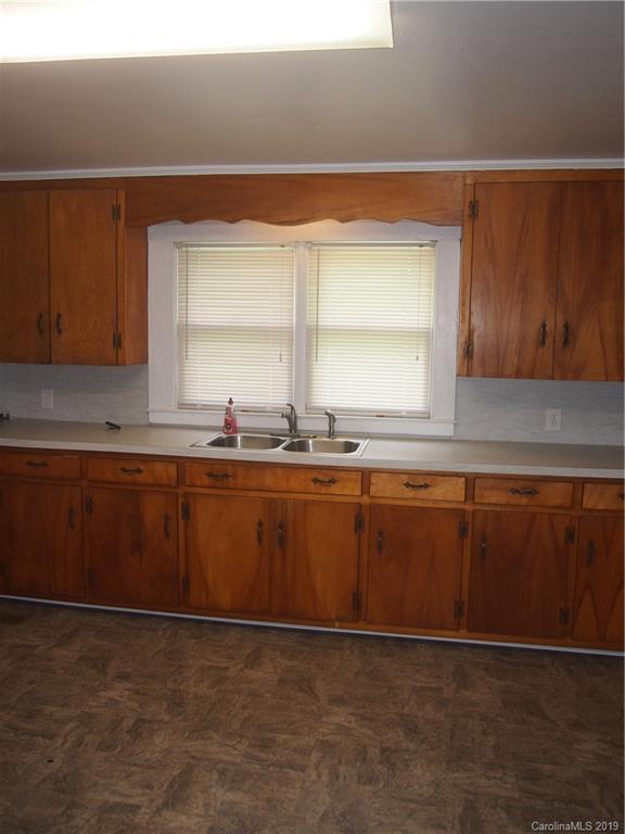 2603 High Ridge Church Road Marshville, NC 28103 - Photo 12 of 16 a kitchen with granite countertop a sink and a stove