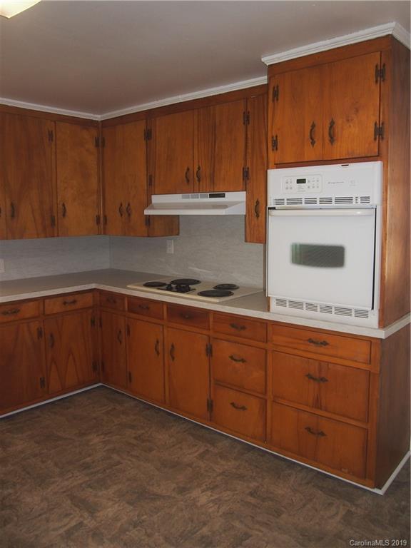 2603 High Ridge Church Road Marshville, NC 28103 - Photo 13 of 16 a kitchen with wooden cabinets and a stove top oven