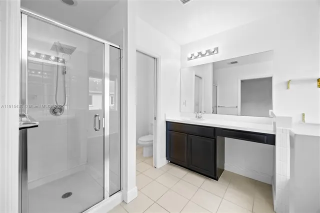 a bathroom with a shower sink and mirror