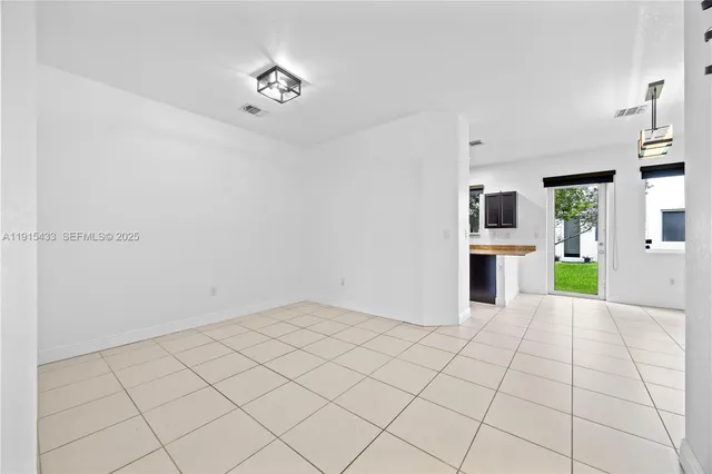 a view of an empty room with a kitchen