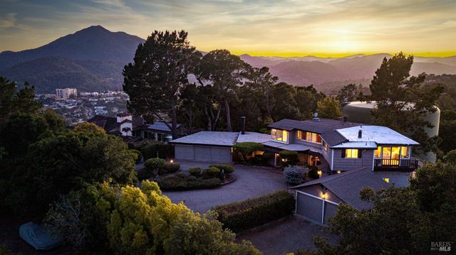 a front view of a house with a yard and a fire pit