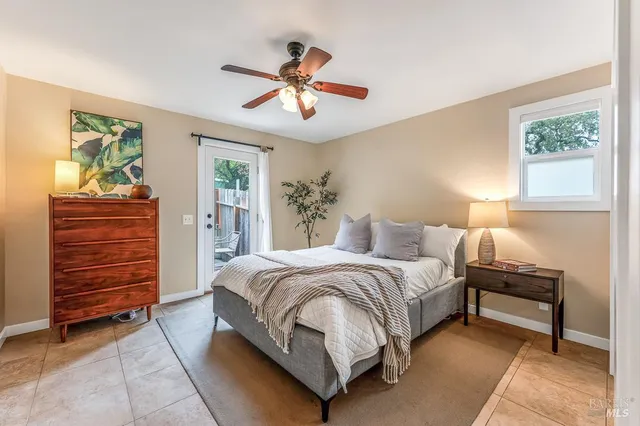 a spacious bedroom with a bed and a chandelier