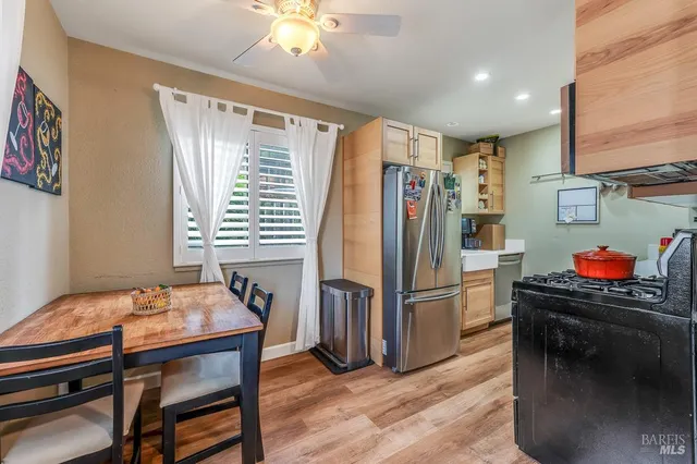 a kitchen that has a lot of cabinets and wooden floor