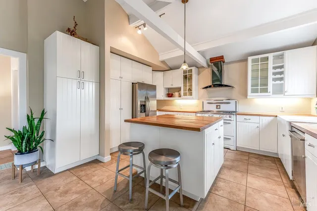 a kitchen with cabinets and chairs