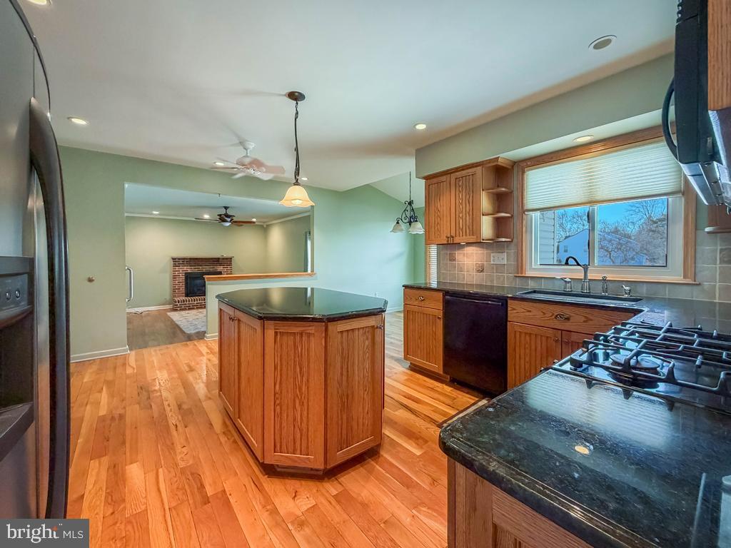 304 Barnsbury Road Langhorne, PA 19047 - Photo 13 of 55 a kitchen with stainless steel appliances granite countertop a stove and a wooden floors