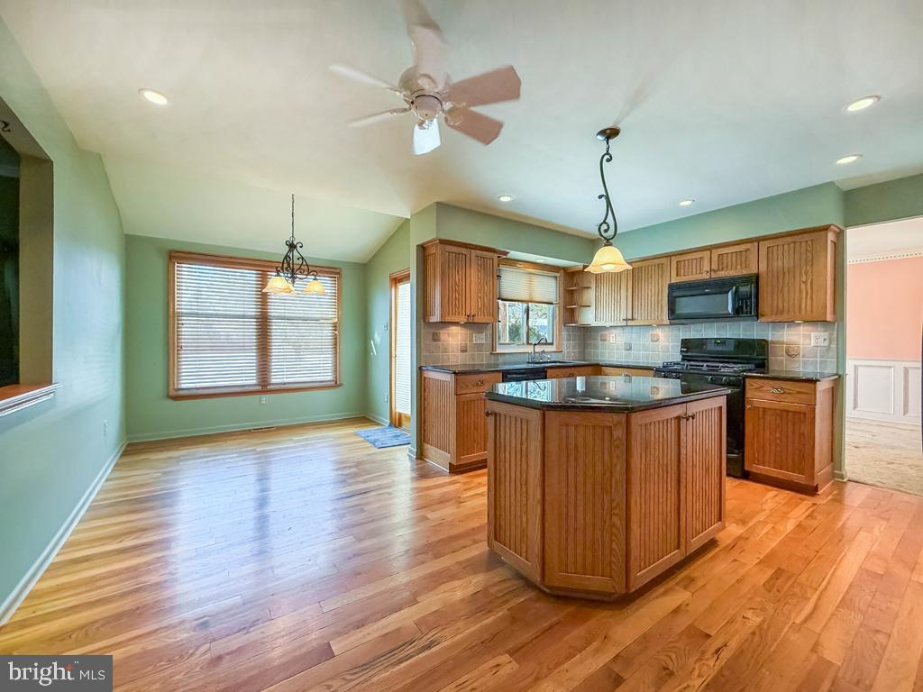 304 Barnsbury Road Langhorne, PA 19047 - Photo 14 of 55 a kitchen with stainless steel appliances granite countertop wooden floors and white cabinets