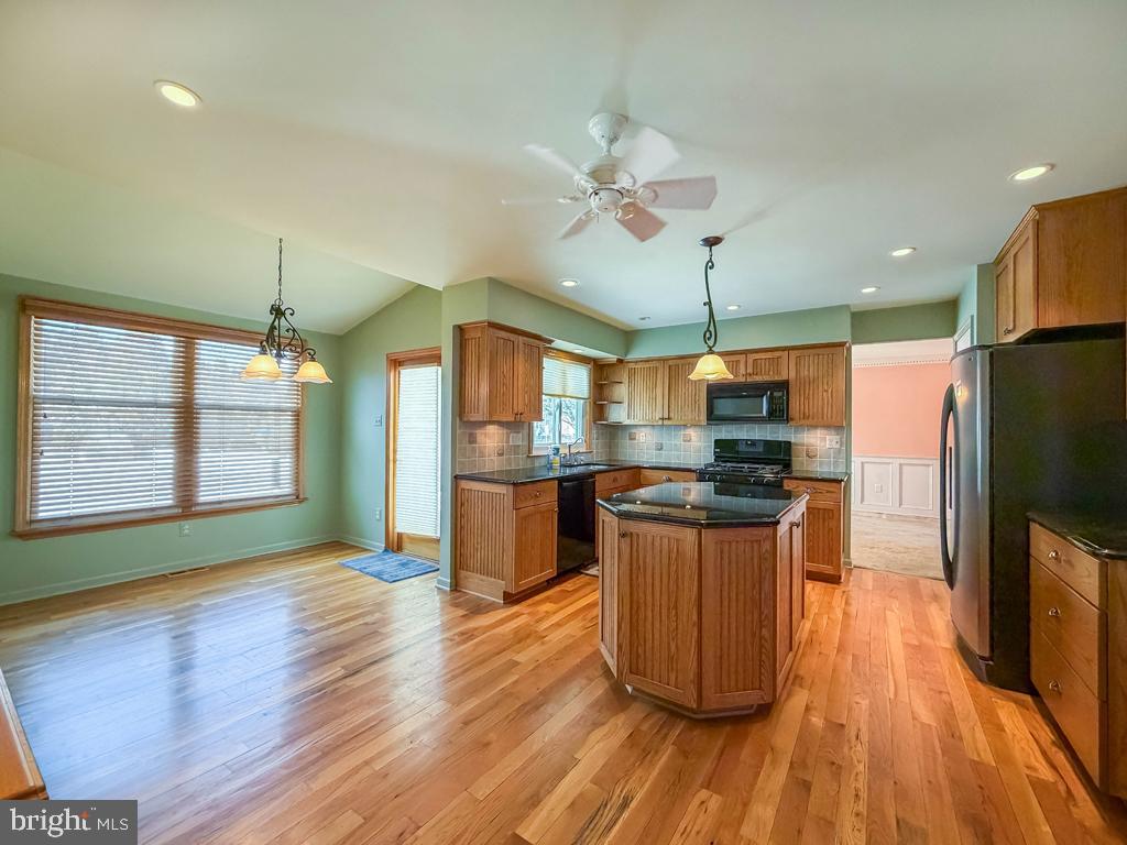 304 Barnsbury Road Langhorne, PA 19047 - Photo 15 of 55 a kitchen with stainless steel appliances granite countertop wooden floors and white walls
