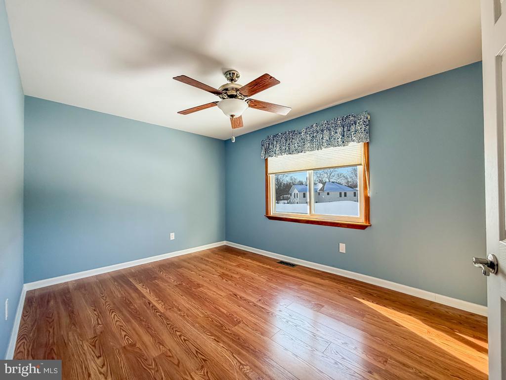 304 Barnsbury Road Langhorne, PA 19047 - Photo 33 of 55 a view of a big room with wooden floor and a ceiling fan