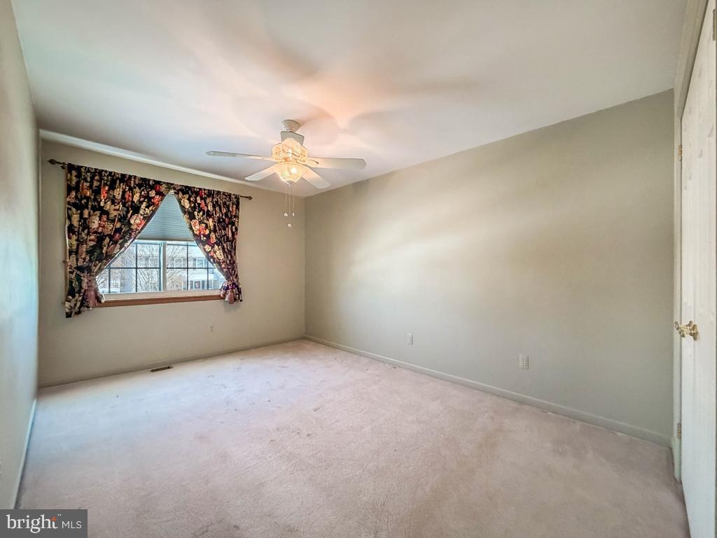 304 Barnsbury Road Langhorne, PA 19047 - Photo 35 of 55 an empty room with windows and chandelier fan