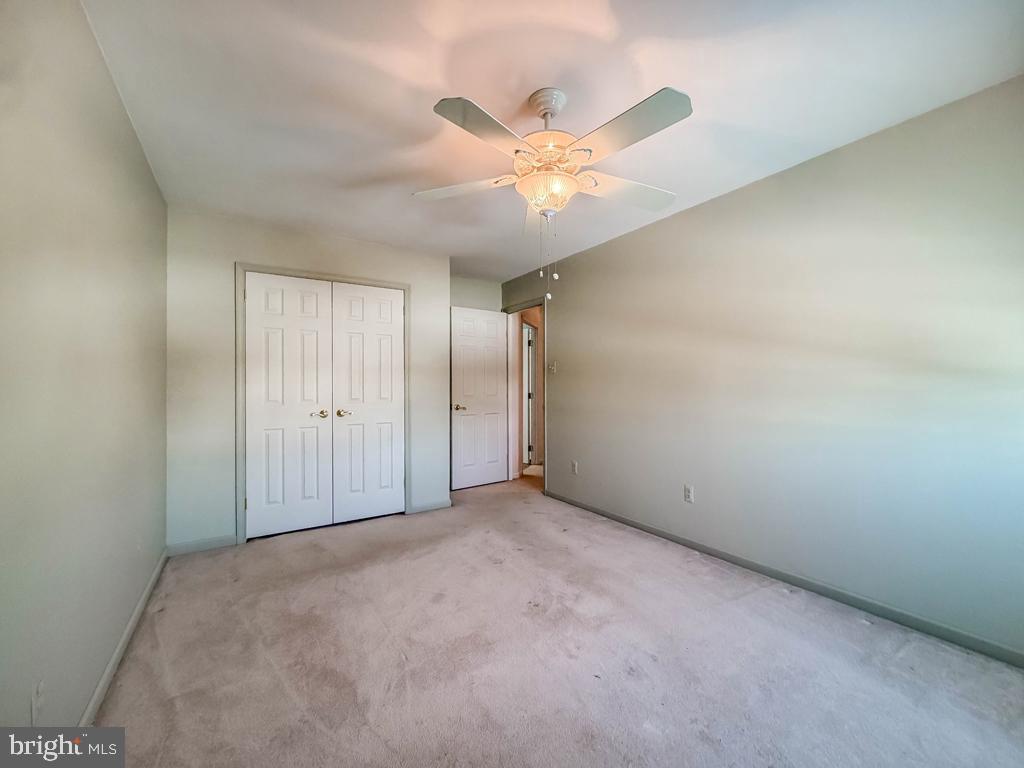 304 Barnsbury Road Langhorne, PA 19047 - Photo 36 of 55 an empty room with a chandelier fan and windows